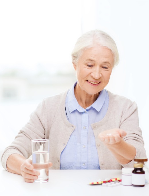 happy-senior-woman-with-water-and-medicine-at-home-picture-id502292732 (1)