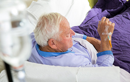 Old patient in bed receiving Gammagard 
