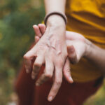 A woman holding her hand in pain