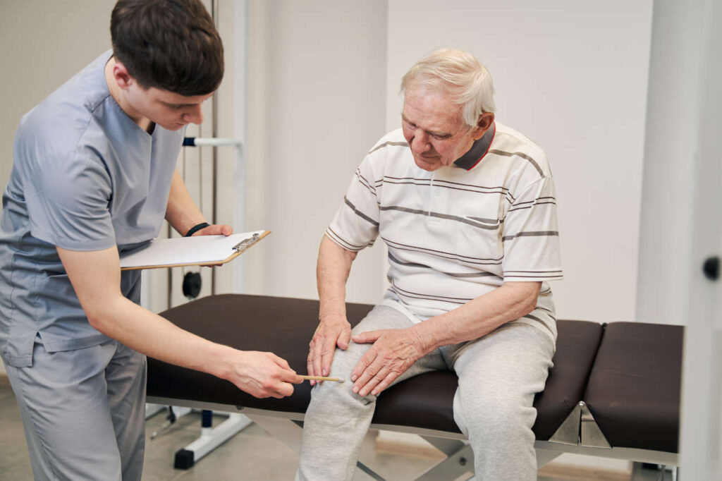 A doctor examining a patient’s leg