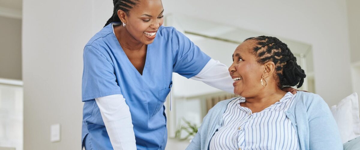 A nurse speaking with a female home infusion patient