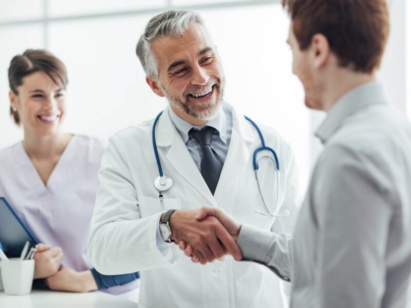 Doctor and pharmacist shaking hands