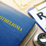 Book about Mesothelioma and stethoscope on a table.