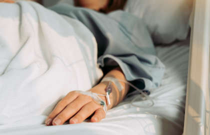 Woman on bed receiving IVIG for an autoimmune disease