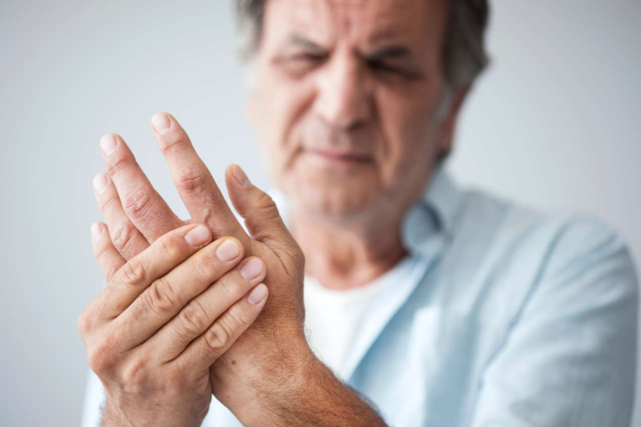 Old man with pain from psoriatic arthritis