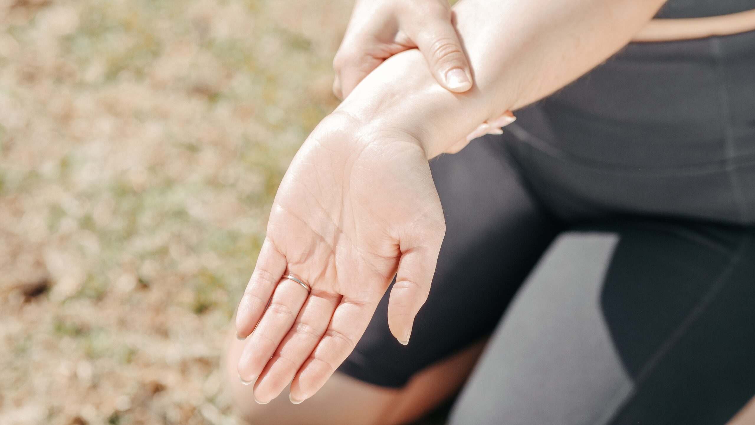 A person with Guillain-Barre syndrome holding her hand in pain