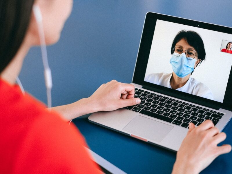 A woman on a video call with a doctor