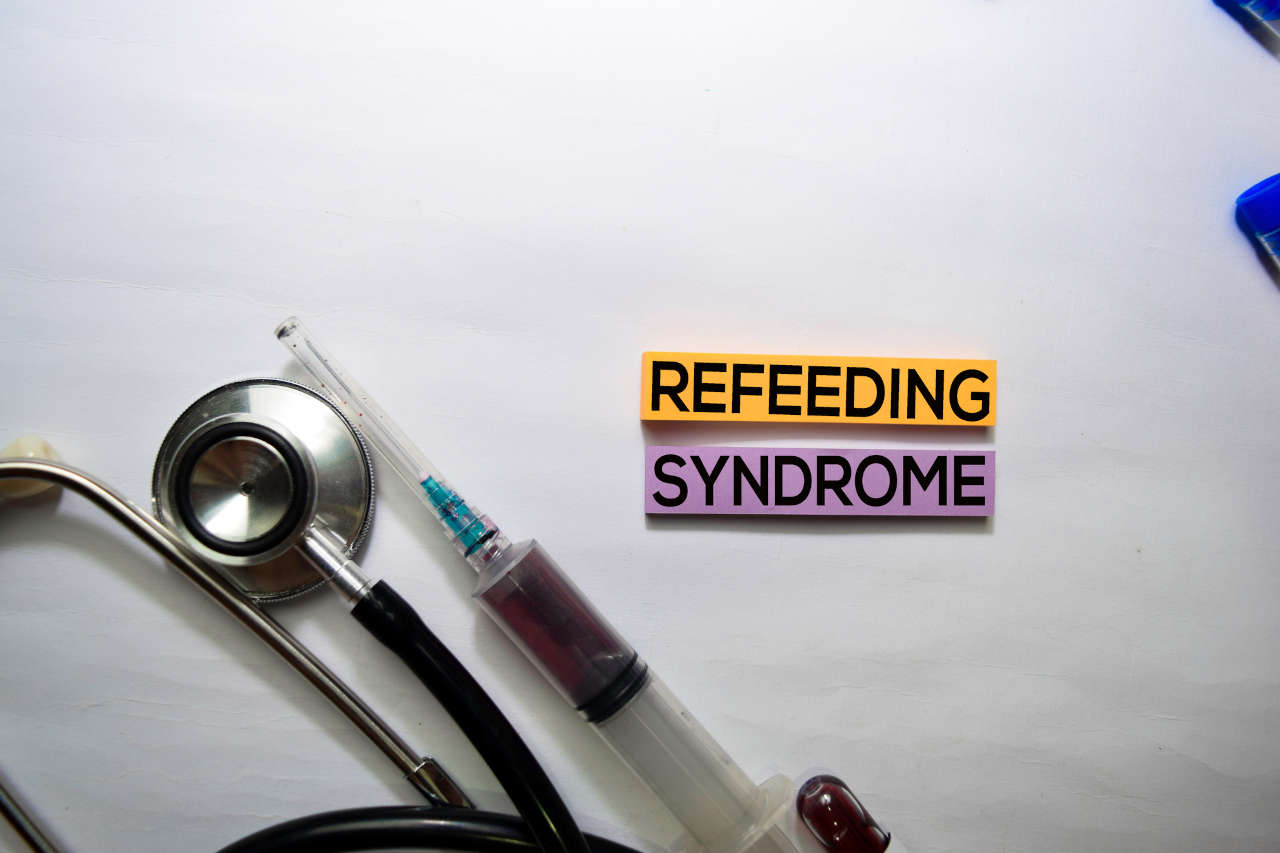 Refeeding Syndrome letters and medical equipment on white background.