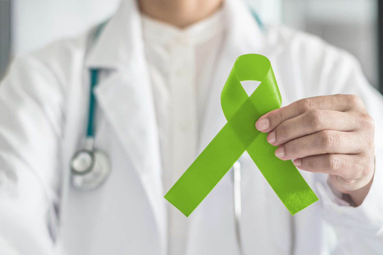 Doctor holding green ribbon for lymphoma awareness