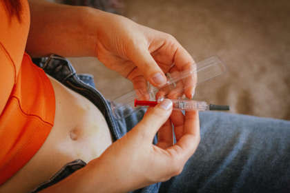 A woman preparing to give herself an SCIG injection