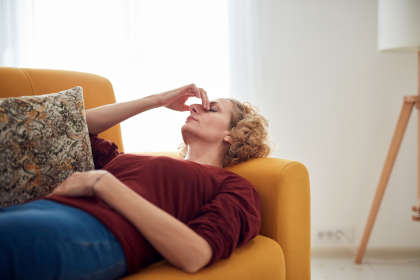 Woman on couch suffering from Trelstar side effects