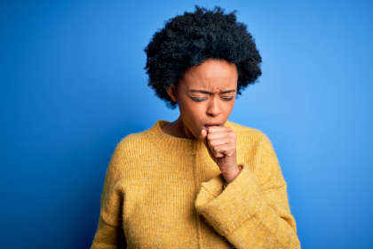 Young woman coughing from taking Hycamtin