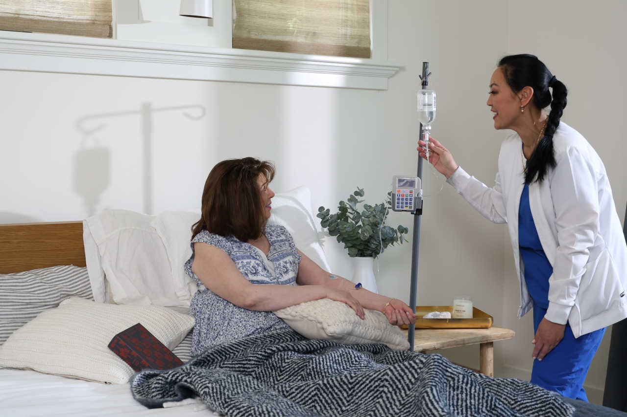 Healthcare professional assisting patient with IVIG