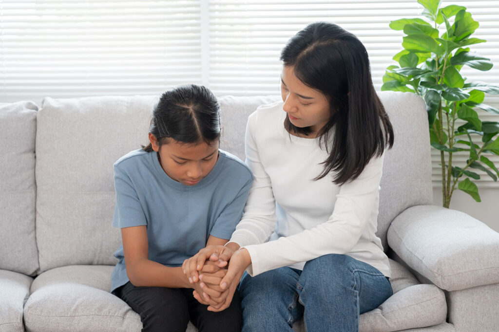a mother talking to her anxious daughter