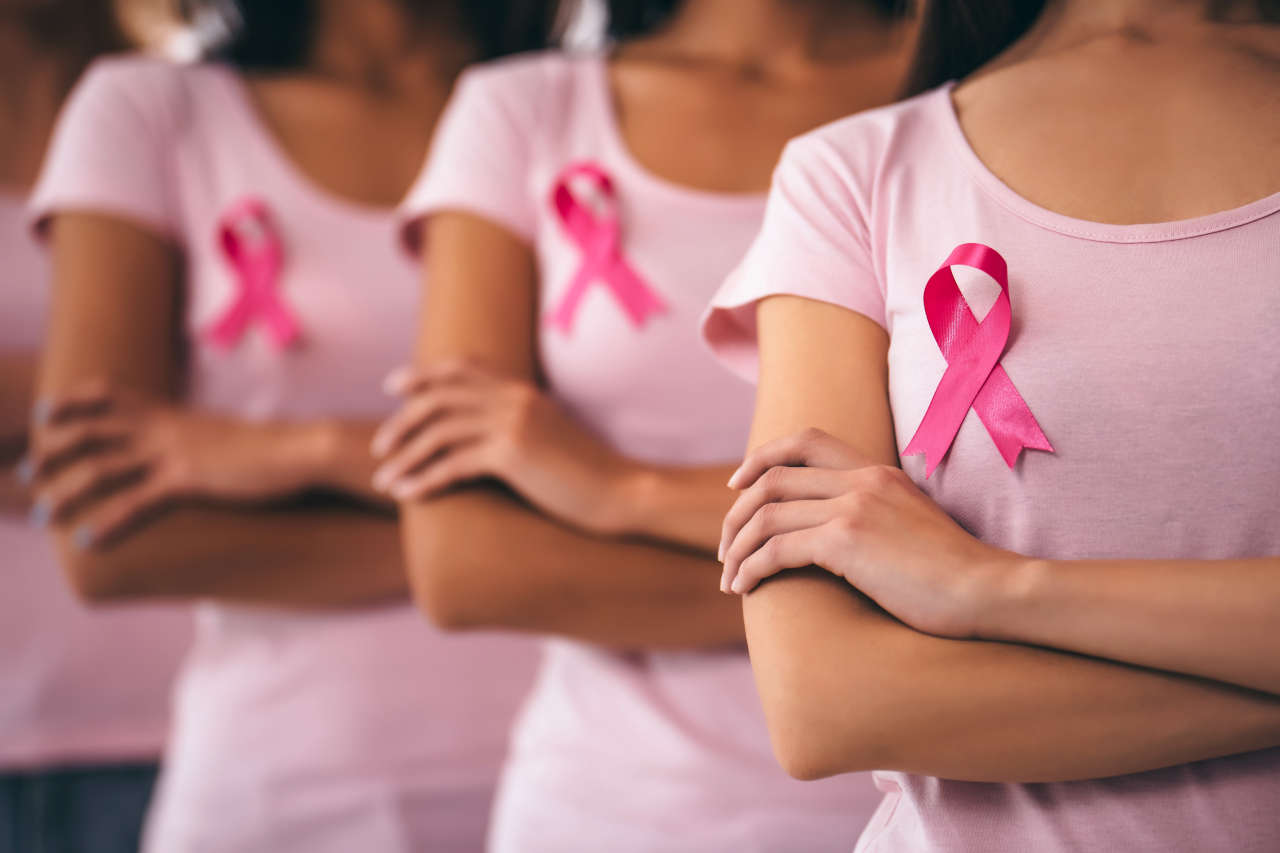 Group of women wearing breast cancer awareness ribbons