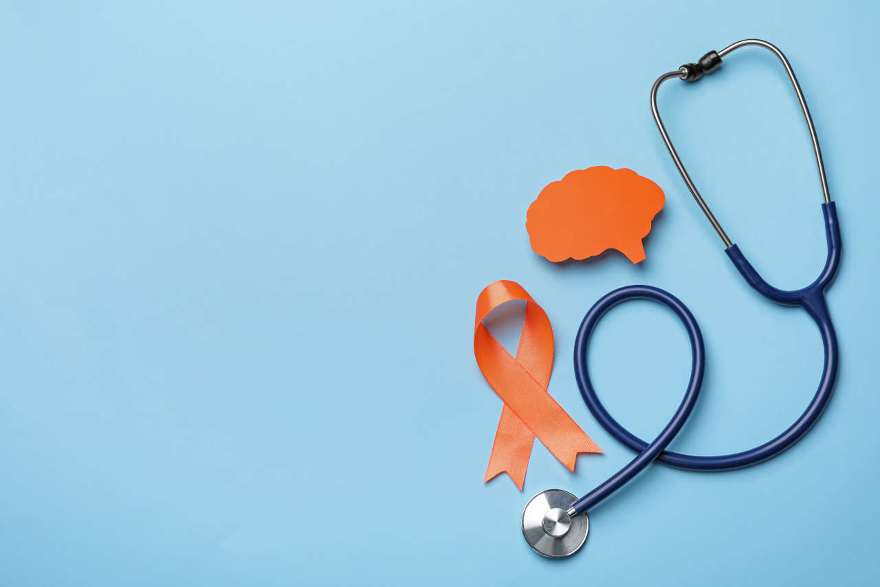 Orange ribbon, stethoscope and paper brain for MS awareness