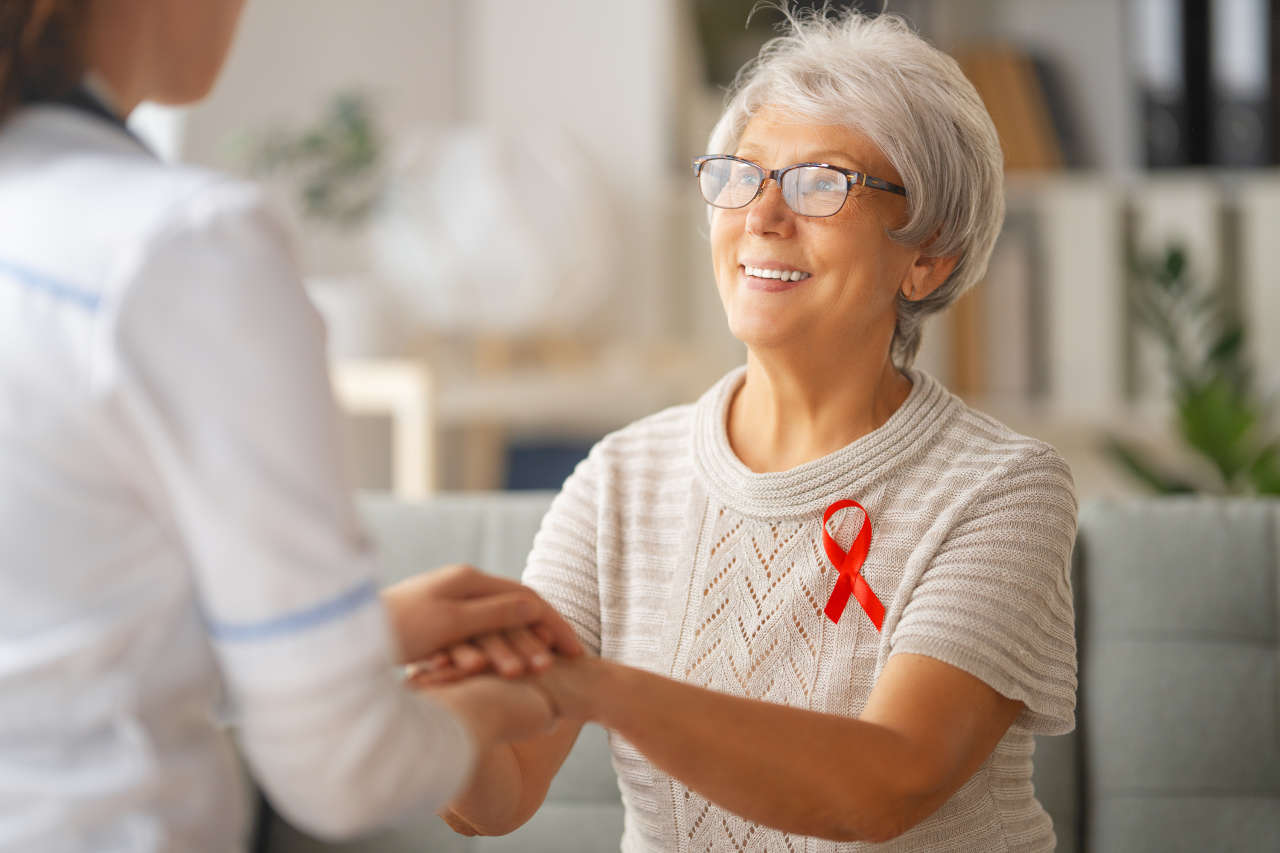 Patient with red ribbon talking to doctor