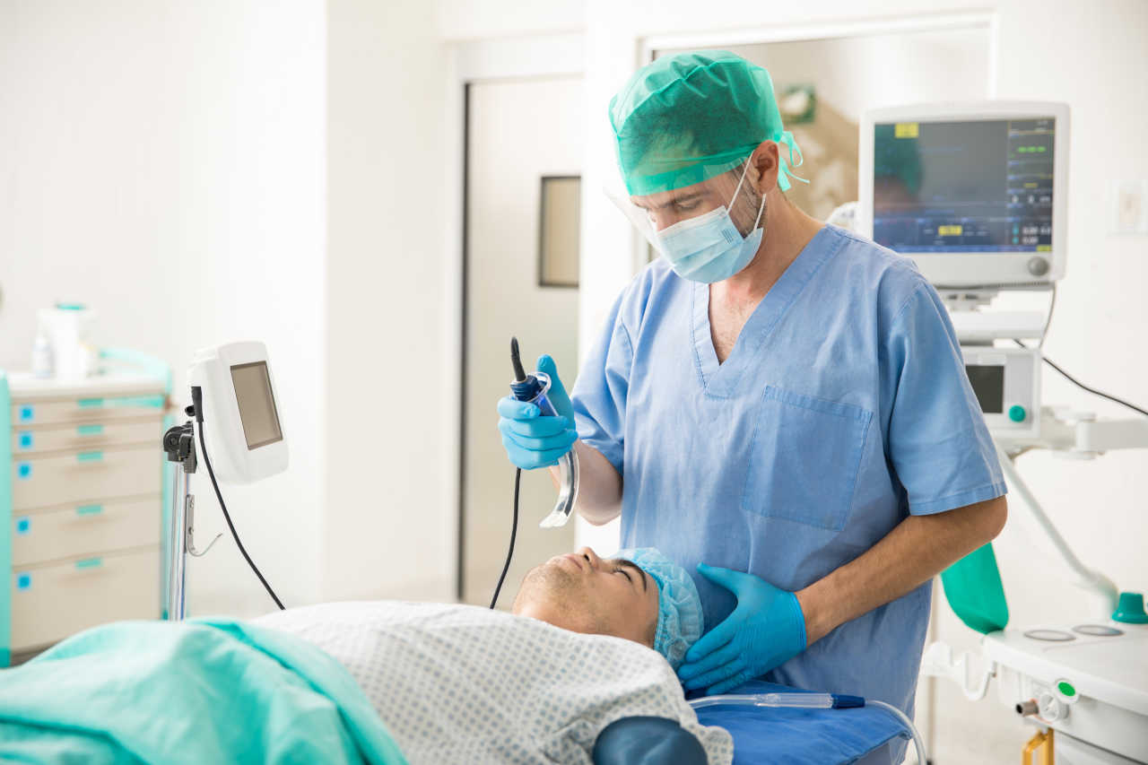 Doctor performing an intubation on a patient with myasthenic crisis