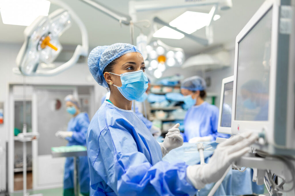 An anesthetist checking a monitor in a surgery room