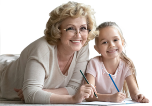 Grandmother and granddaughter lying on the floor, drawing together.