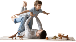 Joyful father lifting his excited young son in the air.