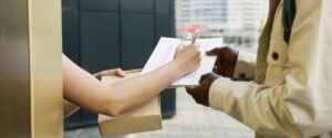 A woman receiving a package with TPN supplies