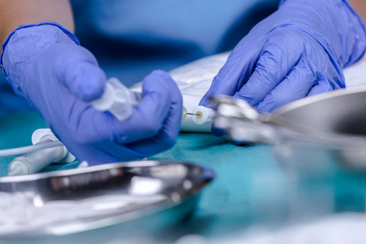 Healthcare worker injecting electrolytes into TPN solution