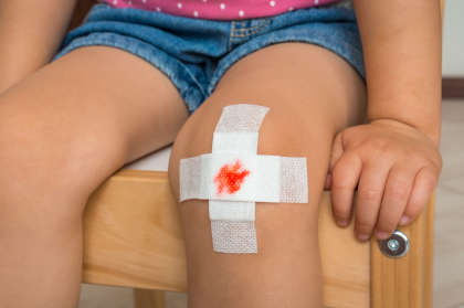 Hemophilia patient with bandages on knee