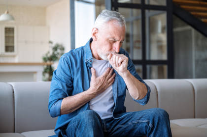 Man with upper respiratory tract infection coughing