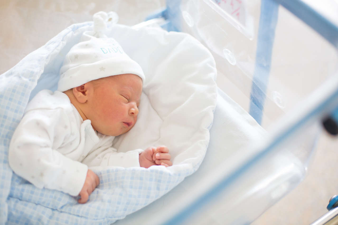 Newborn baby with Hemolytic Disease of the Newborn laying in crib in prenatal hospital