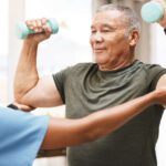 Healthcare worker helping man with physical therapy for CIDP