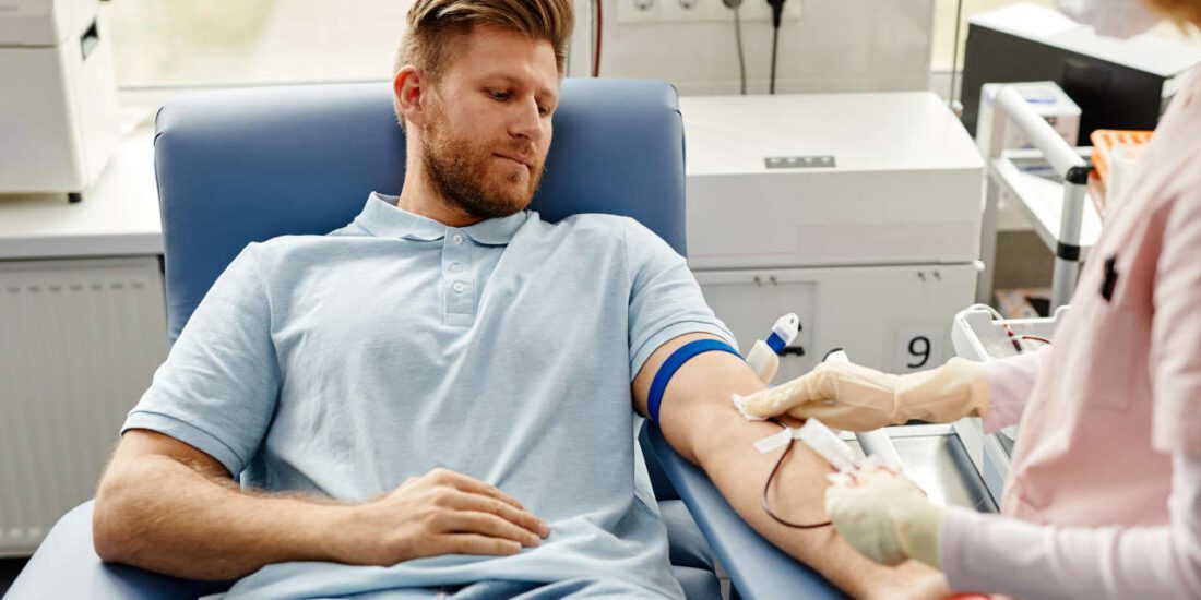 Young man donating blood, which will be used to manufacture IVIG products