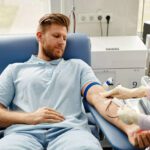 Young man donating blood, which will be used to manufacture IVIG products