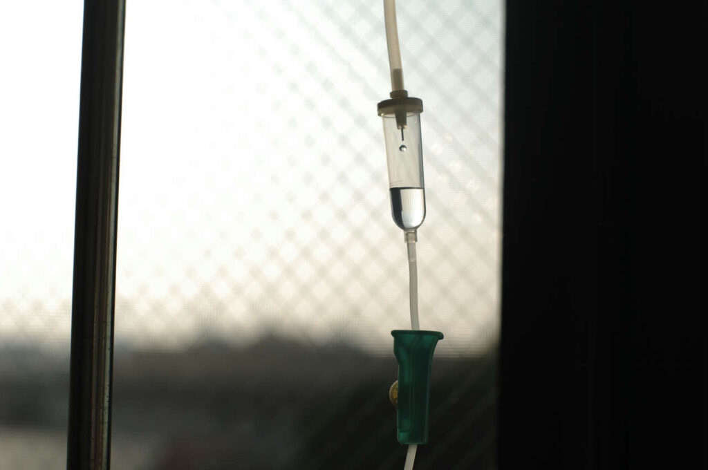 An IV drip hanging from a pole