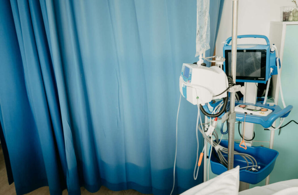 A hospital room with a blue curtain and IVIG serum