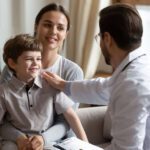 Male pediatrician seeing child with Kawasaki disease