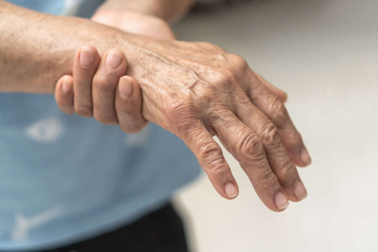 Man with Guillain-Barre syndrome holding wrist