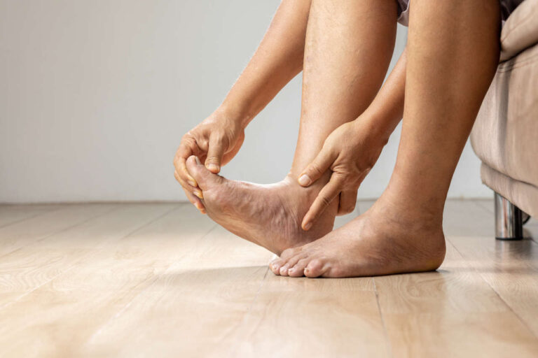 Man with gout massaging feet