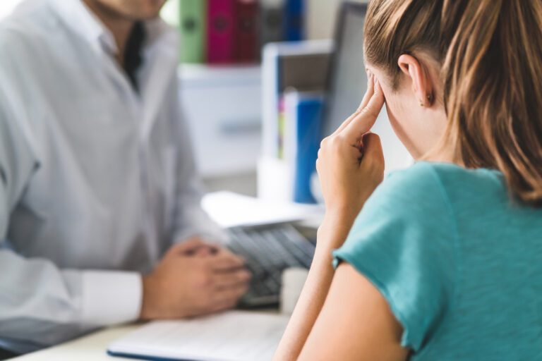 Woman suffering from bad headache