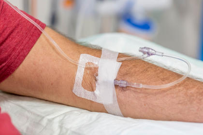 Close up of a man's arm while receiving an IVIG infusion at a hospital