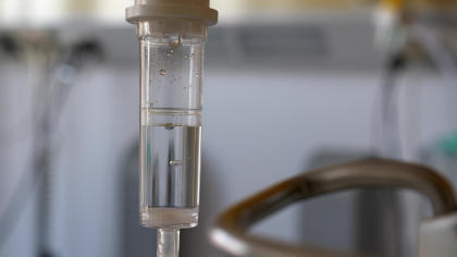 IVIG Dripping from Intravenous Bottle in Hospital Room