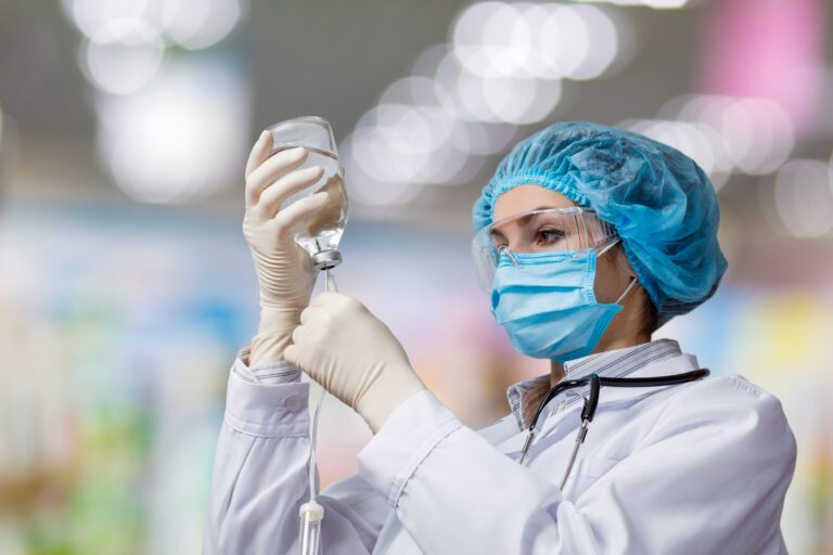 Doctor preparing IVIG bottle