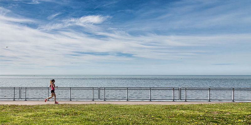 Woman running next to the ocean