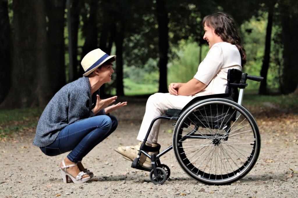 A smiling woman in a wheelchair with her friend