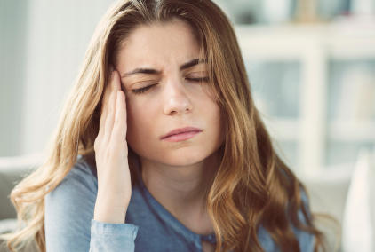 Woman with a headache as a side effect of taking Actemra