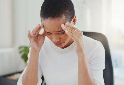 Woman suffering from headaches as a side effect of taking Entyvio