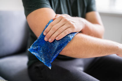 Man using ice pack on elbow joint