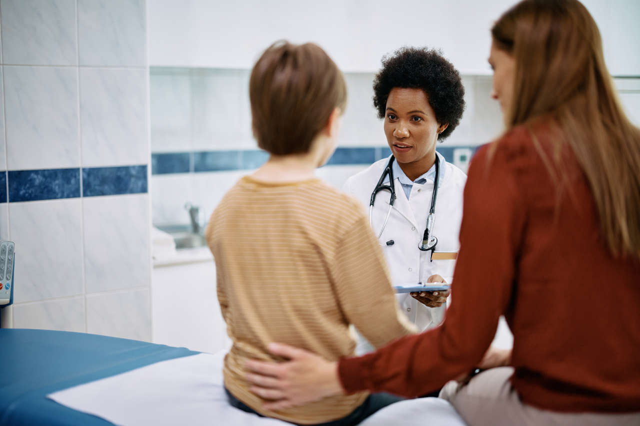 Pediatrician talking to a boy with von Willebrand disease