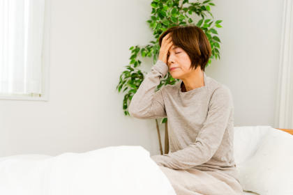 Woman on bed suffering from fatigue from taking sofosbuvir