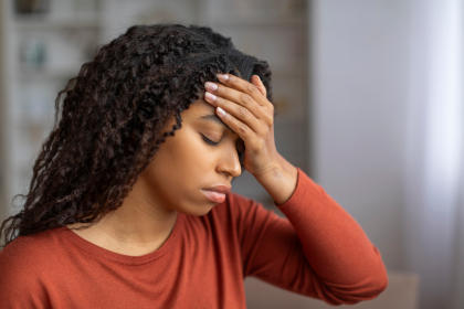 Woman with headache as a side effect of taking Orbactiv